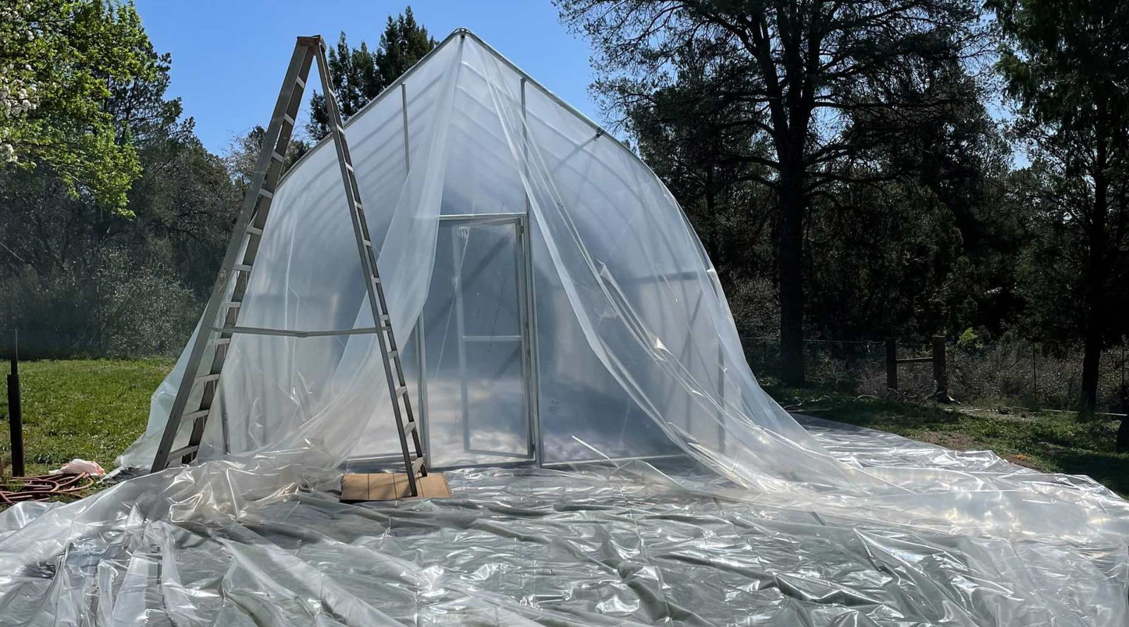 greenhouse plastic drapped on gothic tunnel