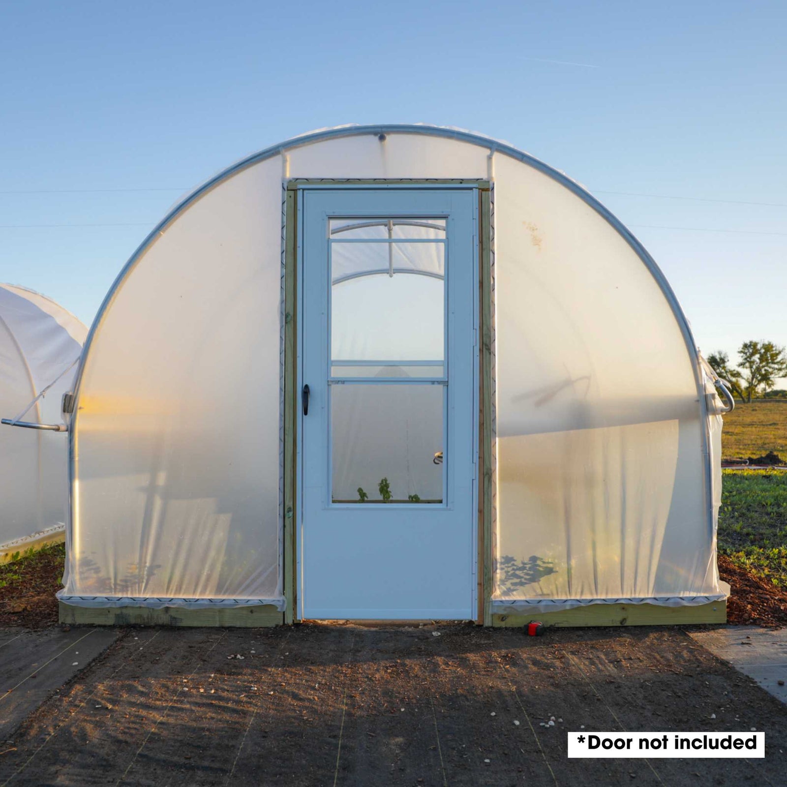Hobby Greenhouse 10' x 12' for backyard growers with an endwall door kit and a standard home door installed (purchased separately)