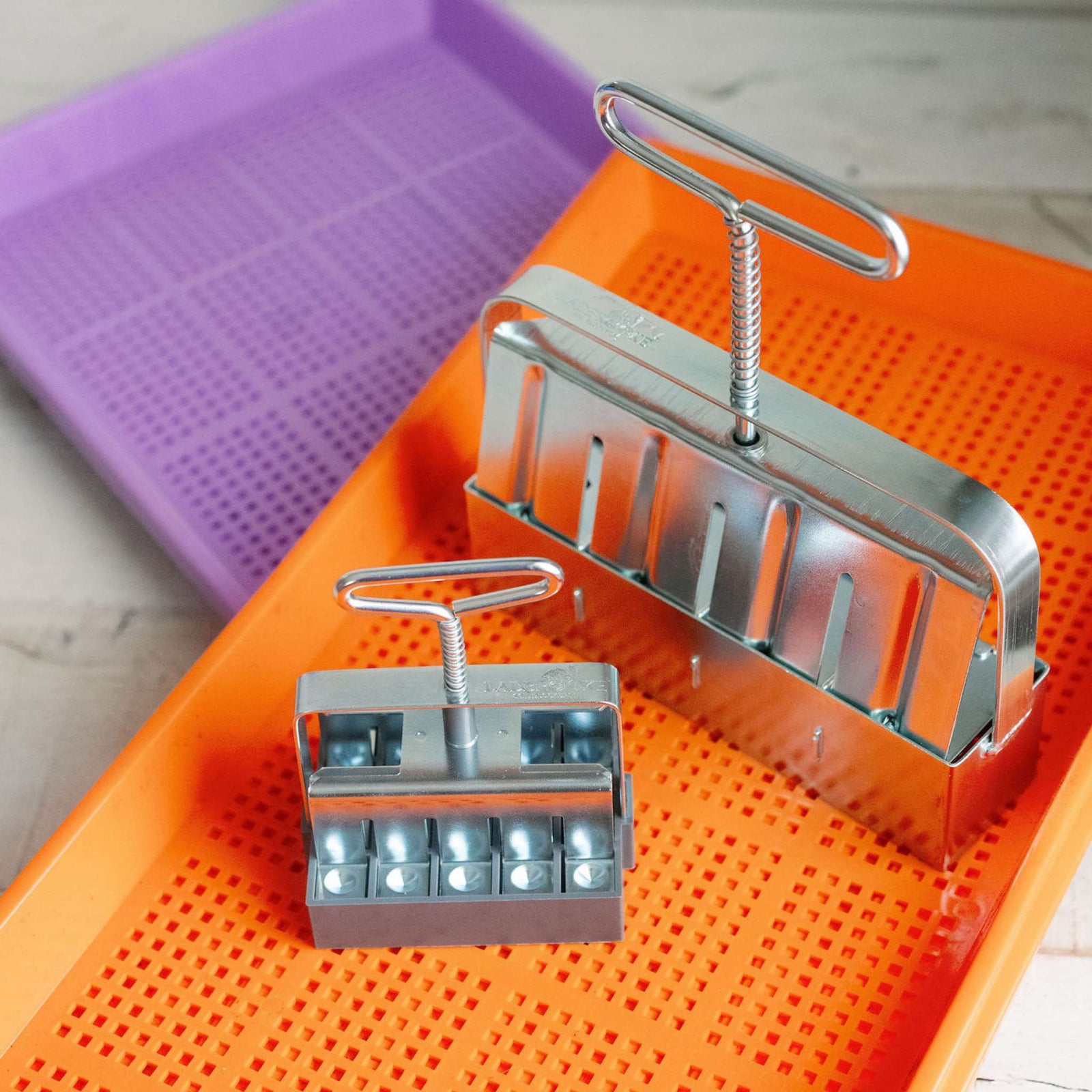 Soil blockers with mesh trays