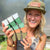 Jill Ragan holding exclusive color line of 6 cell inserts in greenhouse
