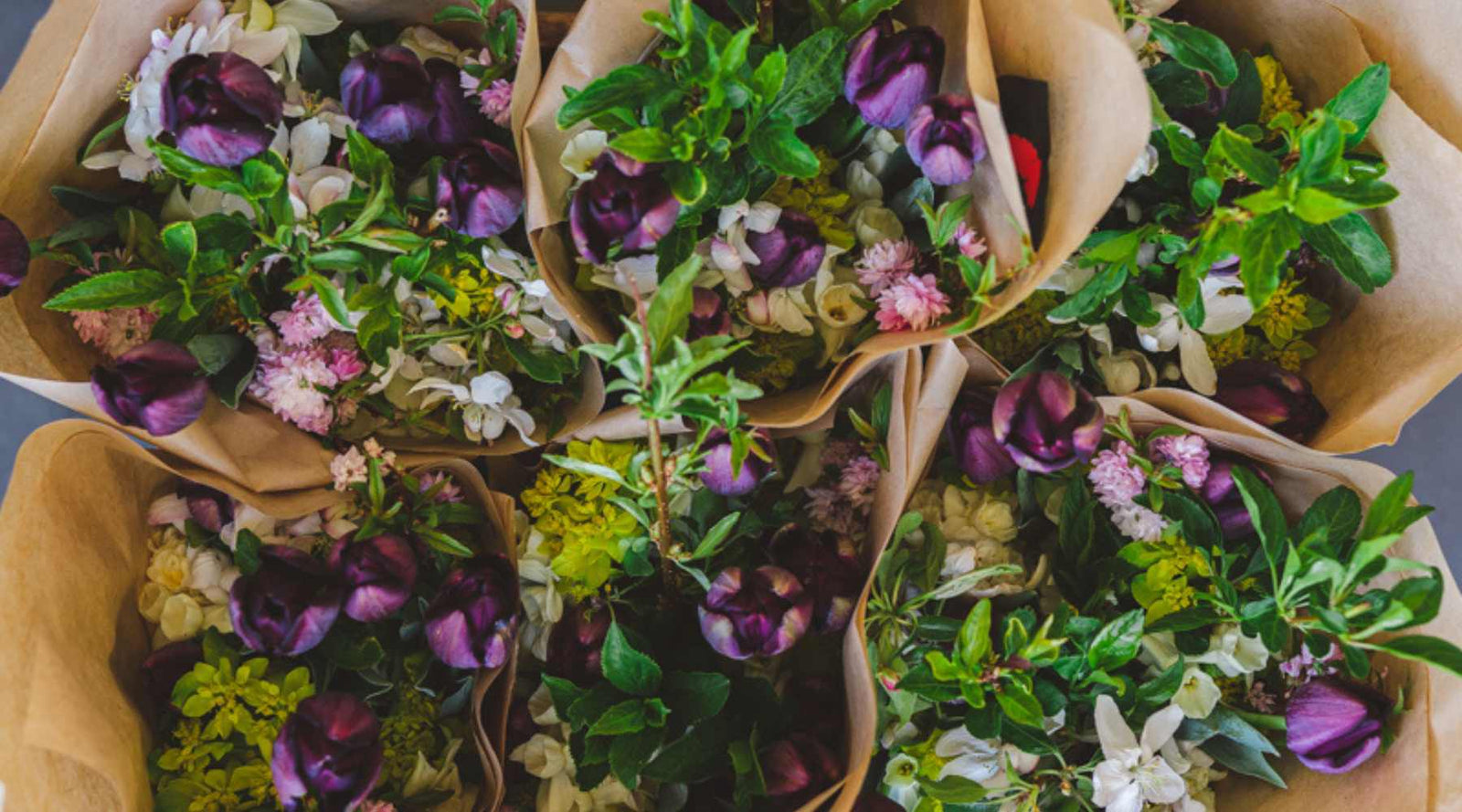 Six paper wrapped bouquets ready to be delivered to flower CSA members