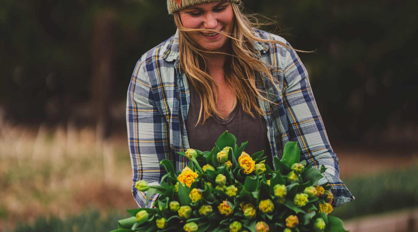 Jessica from Sierra Flower Farm holding a bouquet of harvested tulips