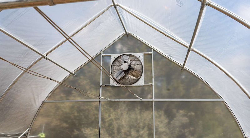 close up of greenhouse ventilation fan installed in gothic high tunnel