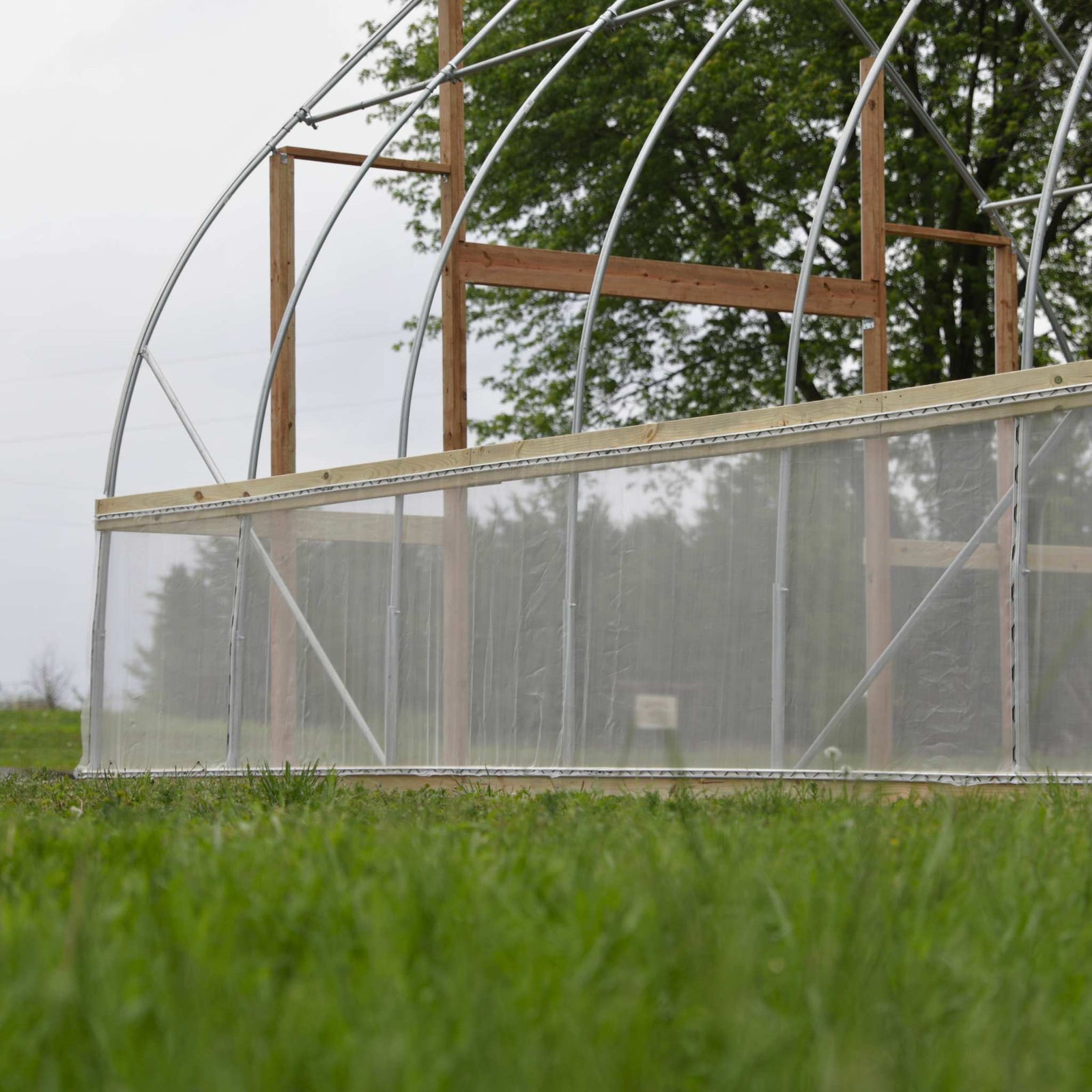 side view of lumber used on baseboards and hipboards and endwalls of gothic diy hoop house