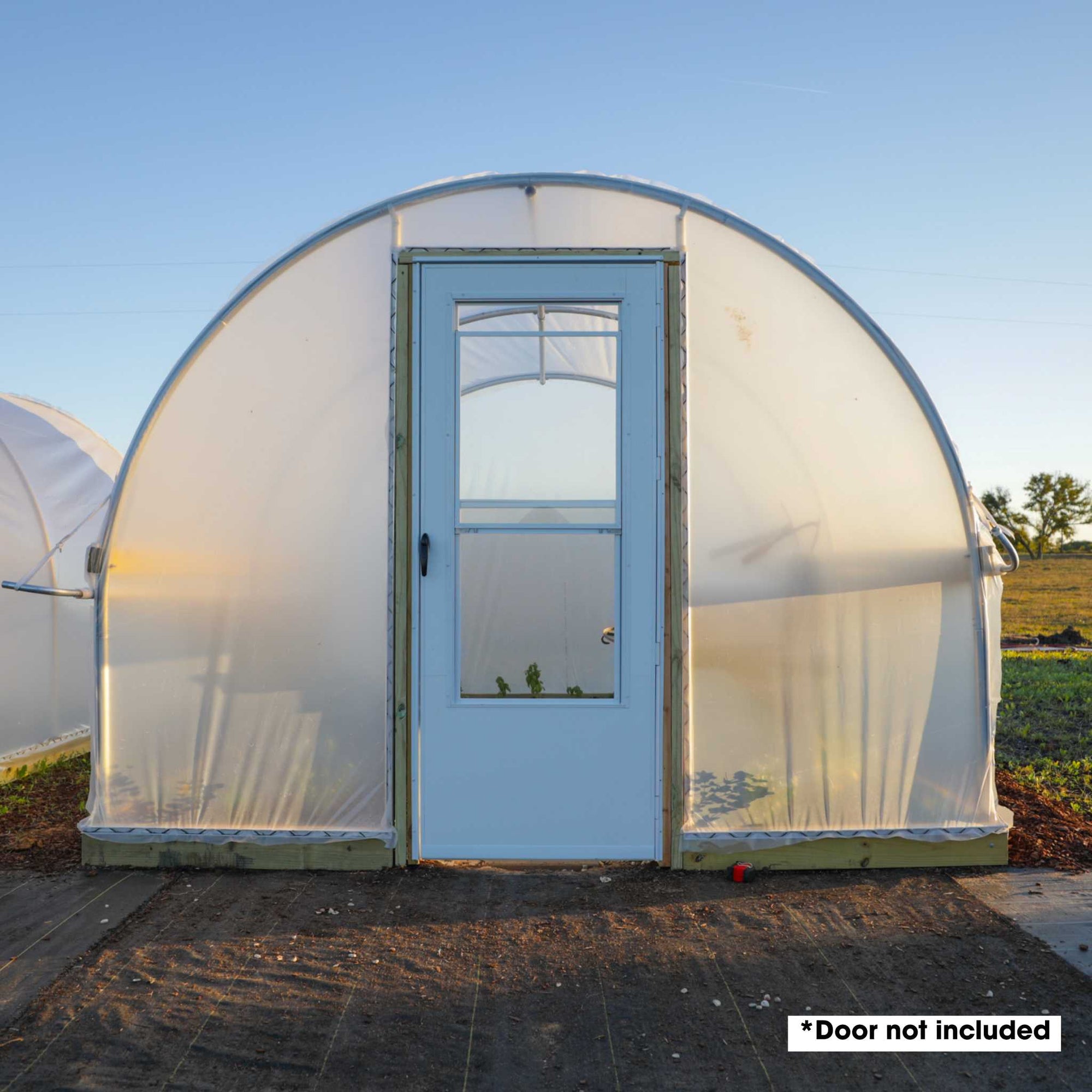 Hobby Greenhouse 10' x 12' for backyard growers with an endwall door kit and a standard home door installed (purchased separately)