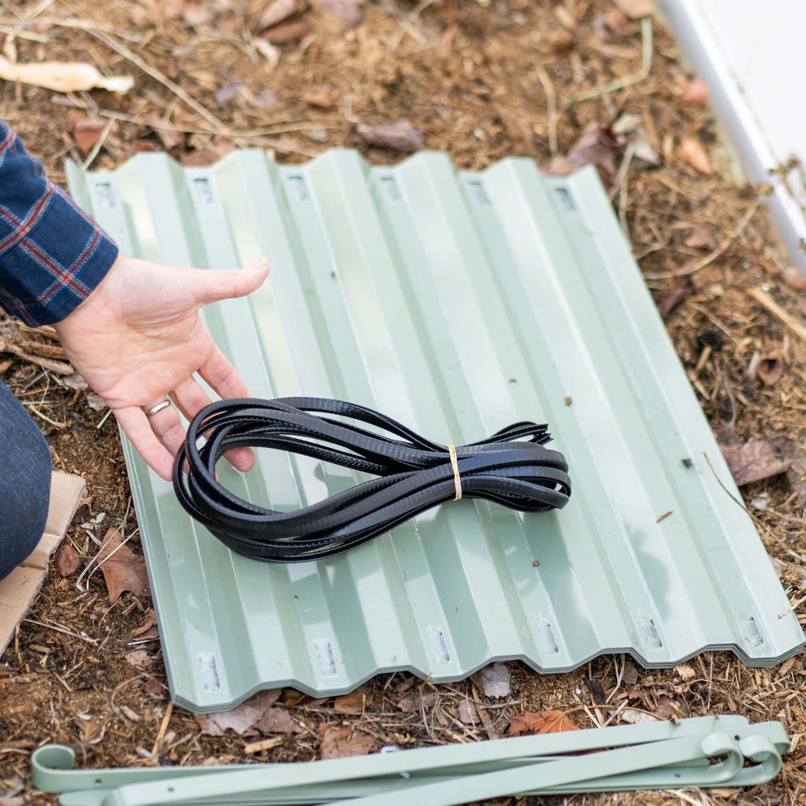 Gro Rite Safety edging resting on panels before assembly with connecting rods piled nearby