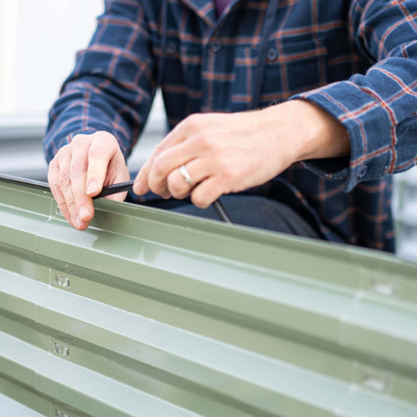 Grower installing safety edging on raised bed