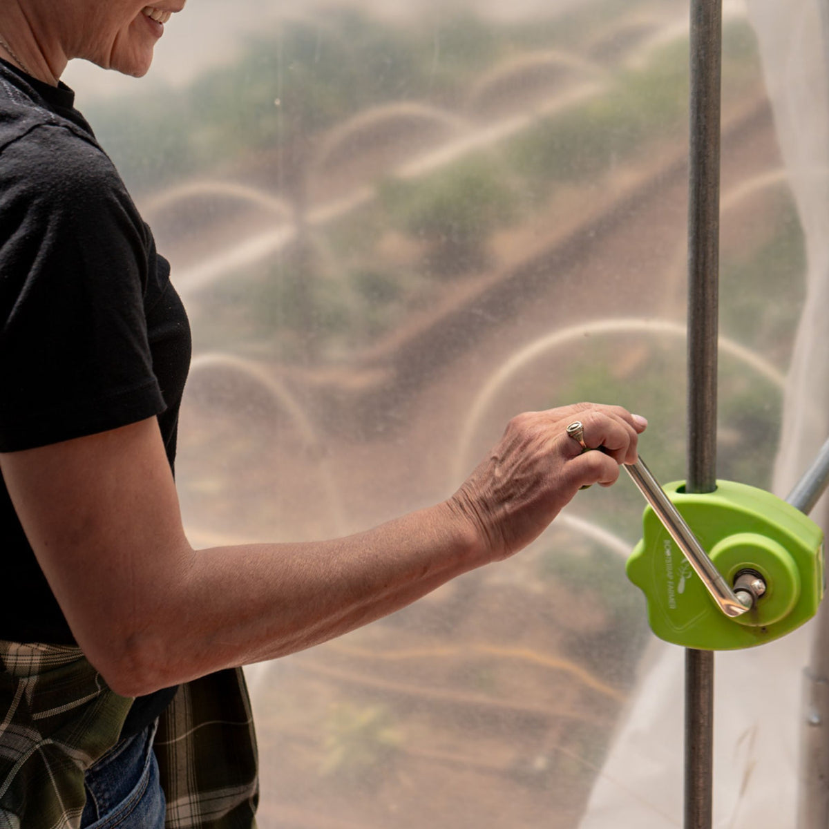 Grower rolling up sidewall with handcrank