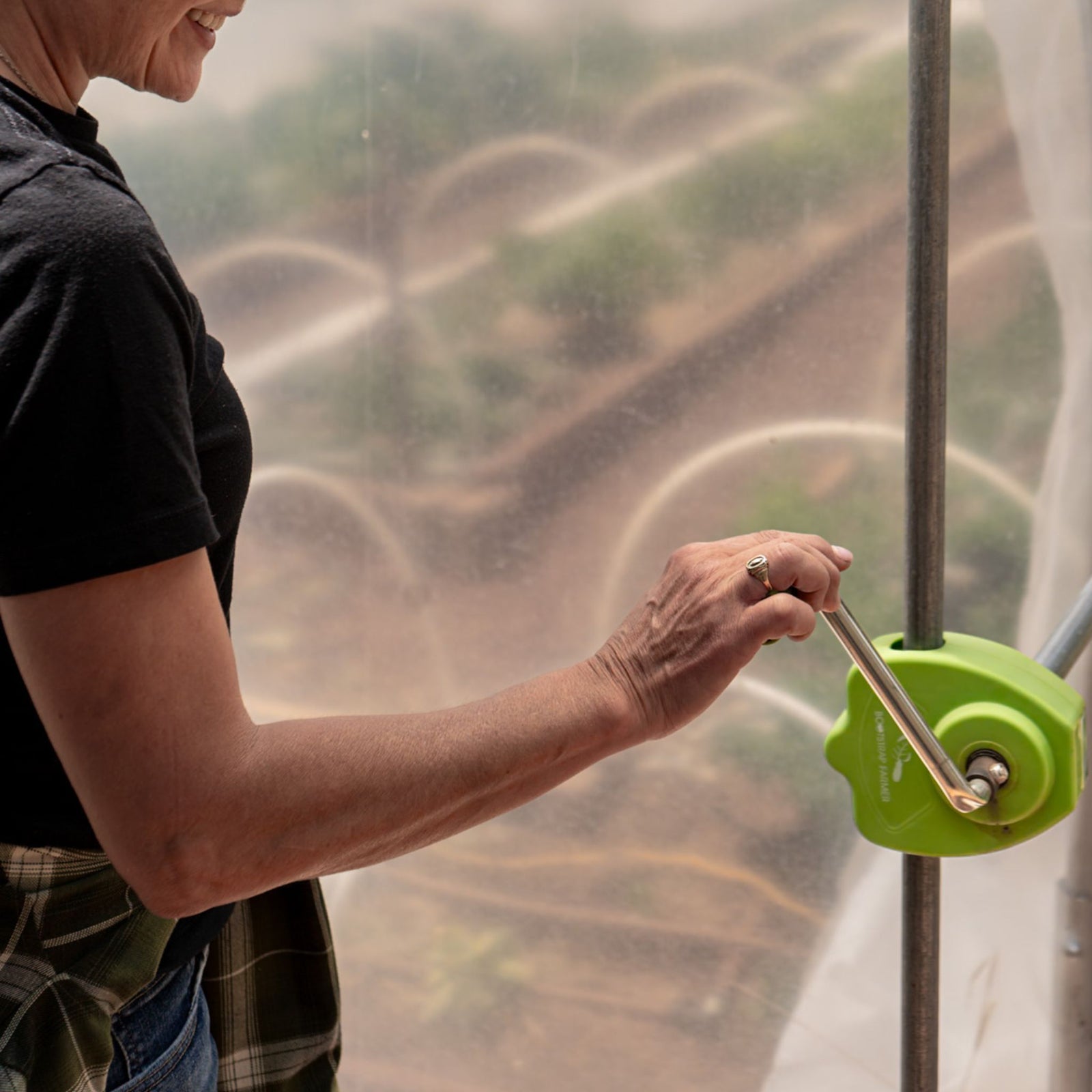 Grower rolling up sidewall with handcrank