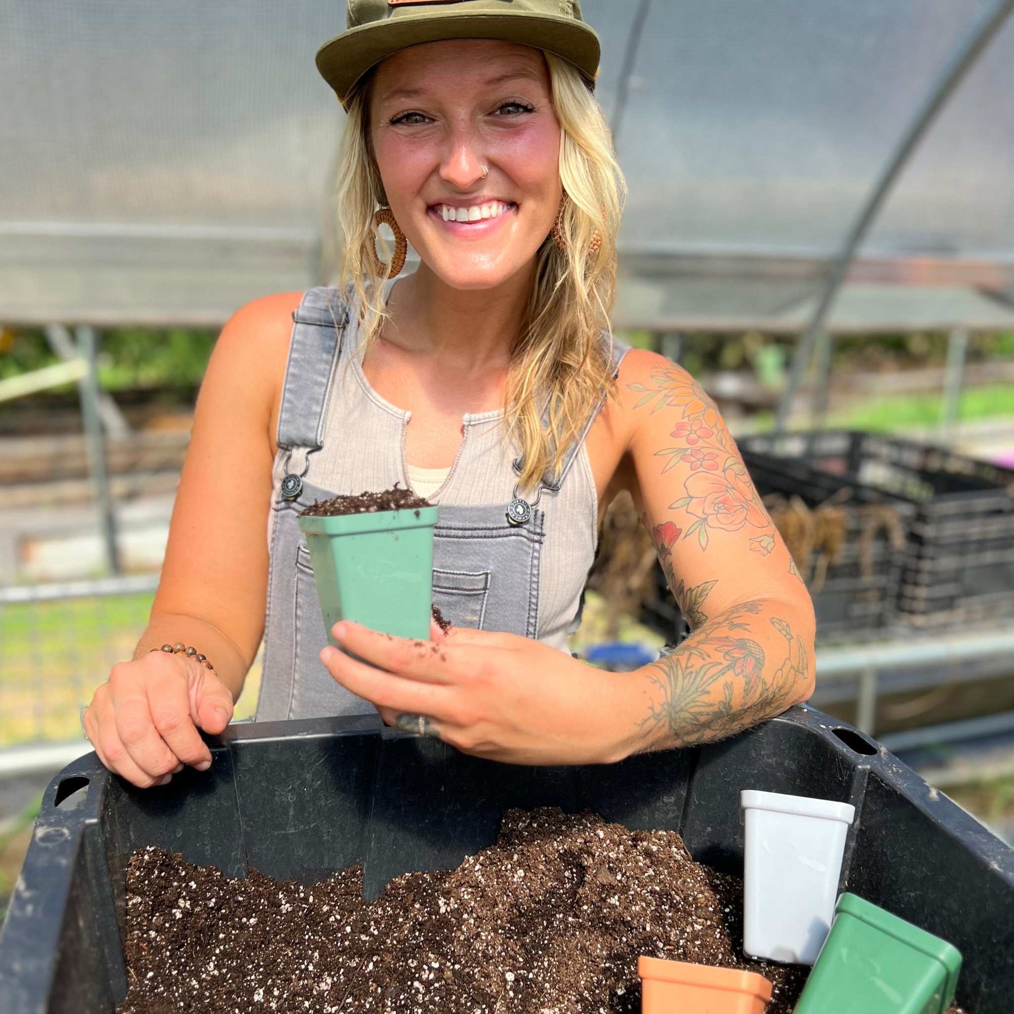 Jill Ragan holding a meadow seed starting pot