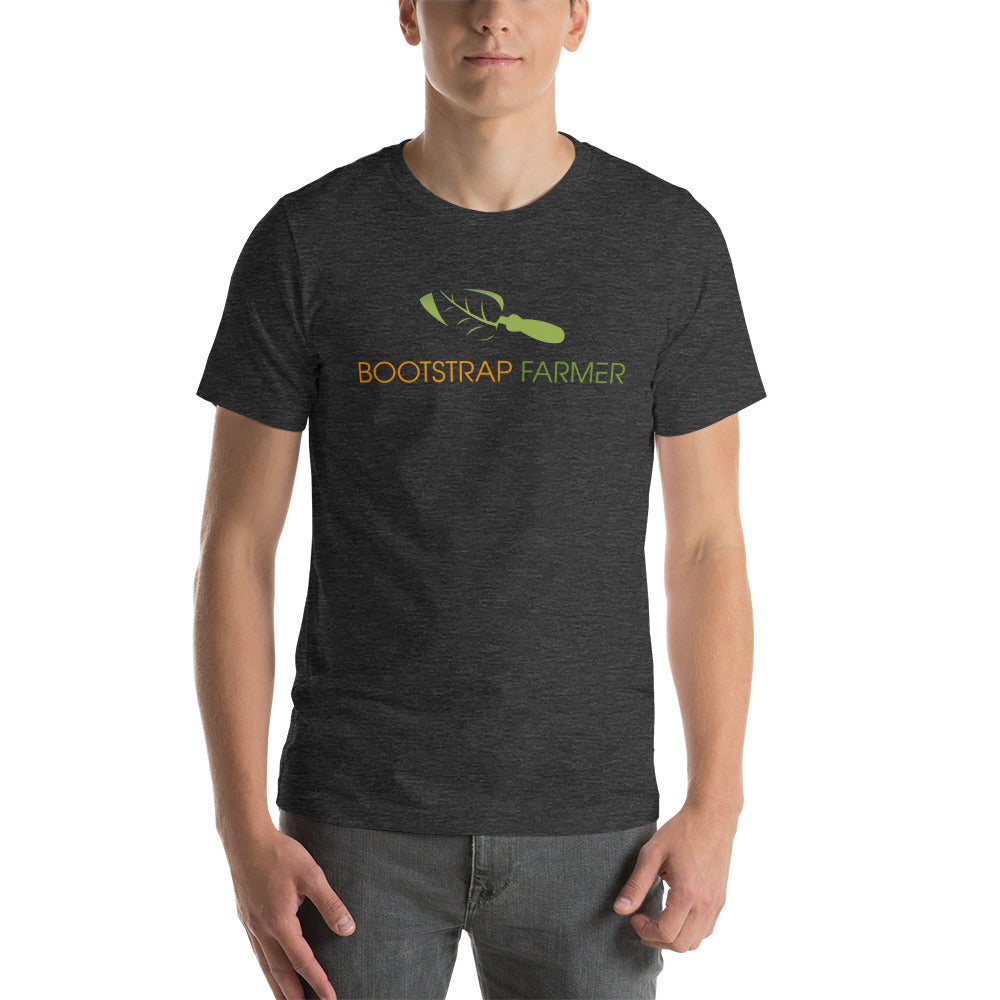 Man wearing a dark heather grey Bootstrap Farmer tee, front view with the green trowel logo on the chest